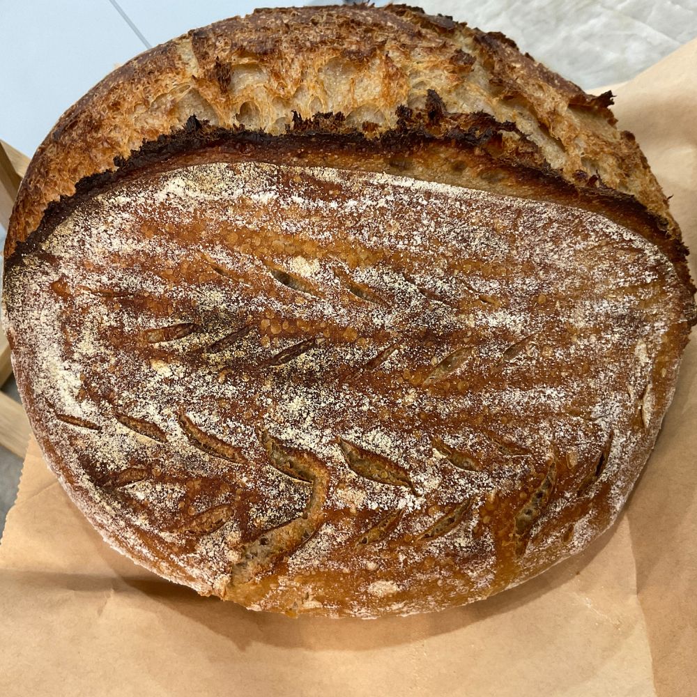 Loaf of bread on brown paper with a light blue background
